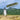 Scenic landscape with a playful figure on a wooden structure showcasing heartfelt gifts online for self love