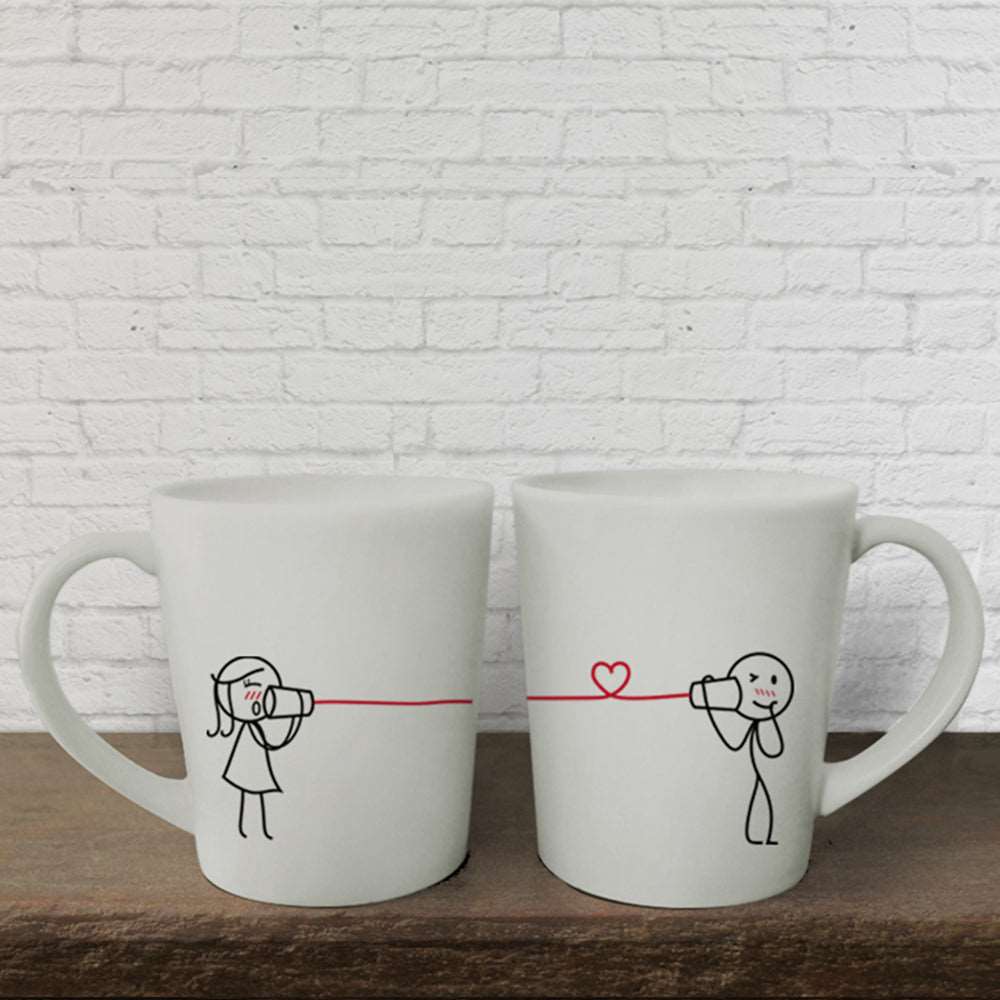 Get charmed with adorable hand-drawn artwork on a pair of elegant white mugs - a perfect anniversary or couples gift!