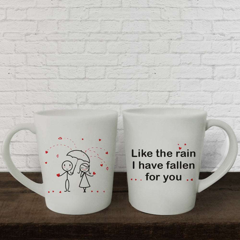 Delight your loved ones with these adorable white mugs featuring a couple under umbrellas - a perfect anniversary or couples gift!