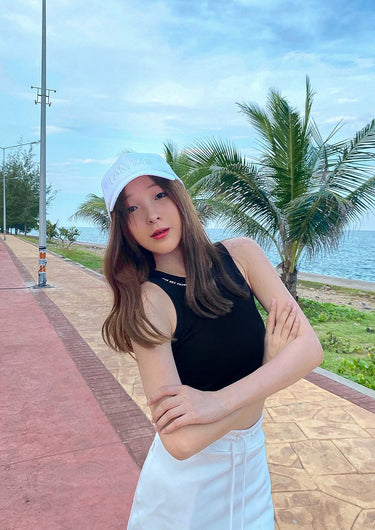 Black sleeveless tank top with light bucket cap