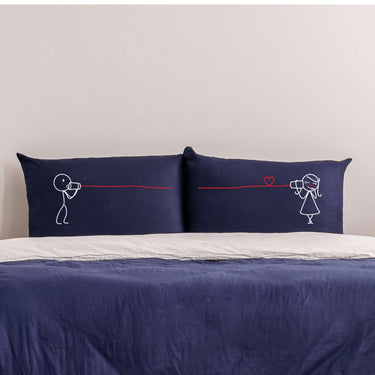 Cute couple pillowcases with playful stick figures and a heart design for romantic bedding