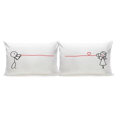 Cute couple pillowcases with playful illustrations of a couple communicating with cans and a heart