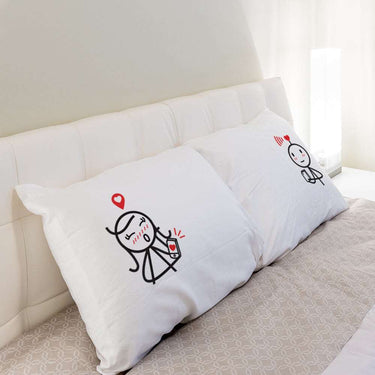 Personalized anniversary pillows featuring cute couple illustrations for romantic bedroom decor