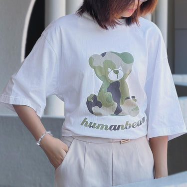 White Human Touch camouflage teddy bear t-shirt featuring a cute bear graphic in green tones
