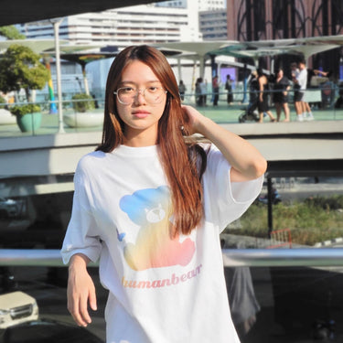 Woman wearing a rainbow bear cool street t-shirt by Human Touch in an urban setting