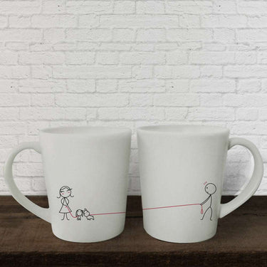 Cute puppy love mugs featuring a couple walking a dog, perfect for sharing coffee together