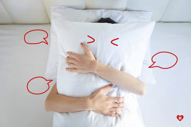 White long pillow with red line-art figures and playful doodles