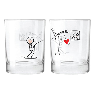 Matching lover's drinkware set featuring playful couple illustrations on decorative glass tumblers
