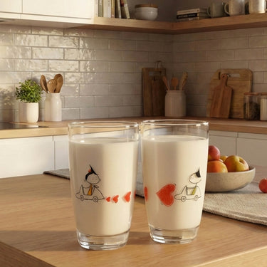 Human Touch romantic couple drinking glasses featuring playful designs and heart motifs in a stylish kitchen setting
