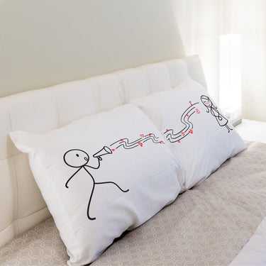 His and hers pillowcases featuring playful designs, perfect as a romantic gift set for couples