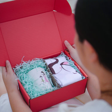 Gift box containing personalized sentimental gifts for mothers with decorative packaging and vibrant colors