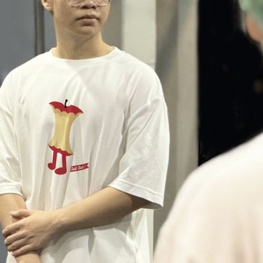 Unique apple-themed 100 percent cotton tee shirt from Human Touch featuring a playful apple graphic