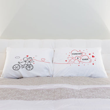 His and hers pillowcases featuring a couple on a bike and hearts, perfect unique wedding gifts