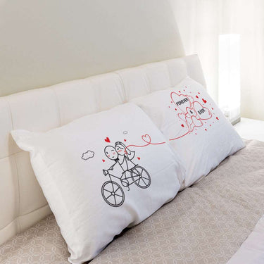 His and hers pillowcases featuring fun couple illustrations, perfect as unique wedding keepsakes