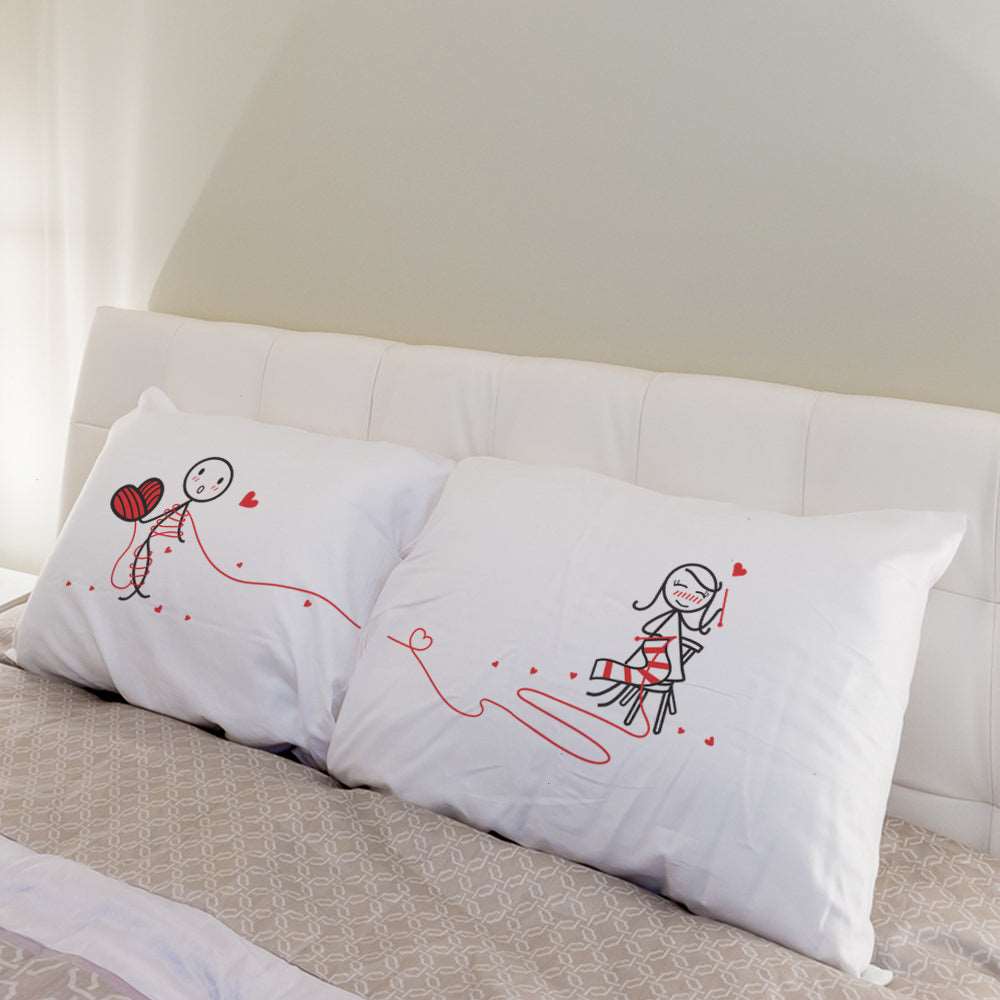 A charming white pillow adorned with a lovely hand-drawn couple—a perfect anniversary gift for him or her.