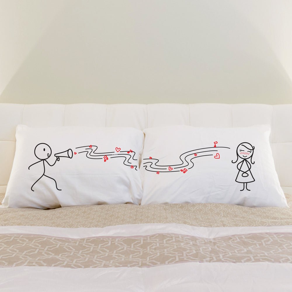 Two charming pillows adorn the bed, perfect for a couple; an ideal anniversary gift for him or her.