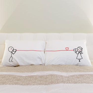 Cute couple pillowcases featuring playful design of two characters communicating with a string and heart