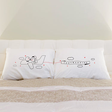 Just married his and hers pillowcases featuring a plane with 'Just Married' banner, perfect Love Takes Flight unique wedding gifts for him and her.