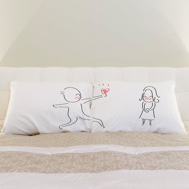 His and hers pillowcases from Human Touch featuring cute couple illustrations for wedding keepsakes decor