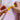 Hands wrapping a meaningful gift with a yellow ribbon while learning how to choose meaningful gifts