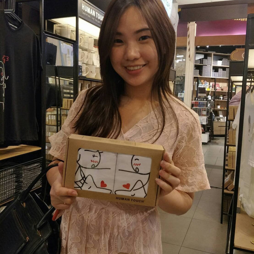 Happy winner holding romantic couple gifts from Human Touch shop activity lucky draw