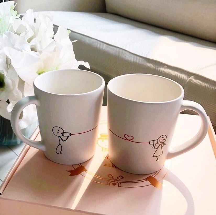 Charming matching mugs for couples featuring playful illustrations to enhance your coffee experience