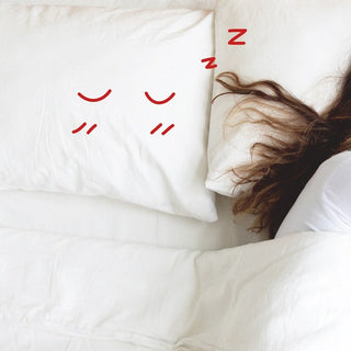 A person sleeping comfortably on a soft pillow, illustrating how to choose the perfect pillow gift for relaxation