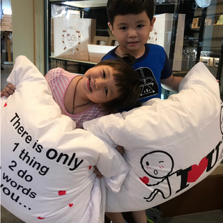 Two children holding large decorative pillows with a loving message, perfect for heartfelt gifts for siblings