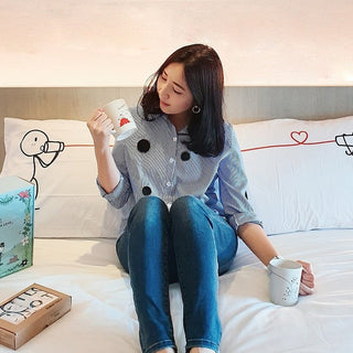 Meaningful gifts for loved ones showcased with a woman enjoying a cozy moment in a stylish bedroom