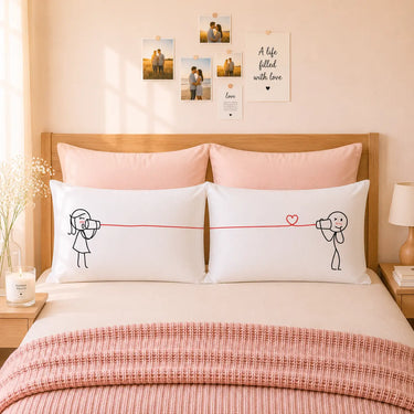 White couple pillowcases with line-art figures and a heart, matching front pair