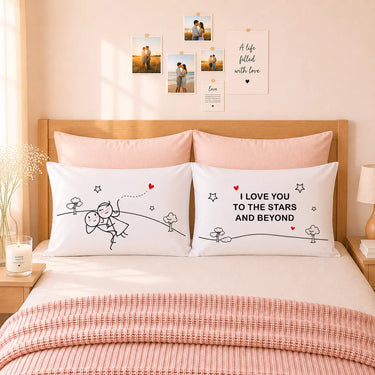 Pair of white couple pillowcases with line-art stars and hearts and the phrase text