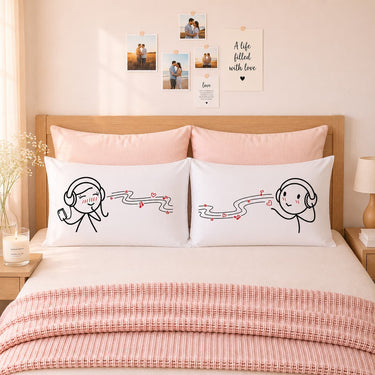Pair of white couple pillowcases with cartoon headphones and hearts