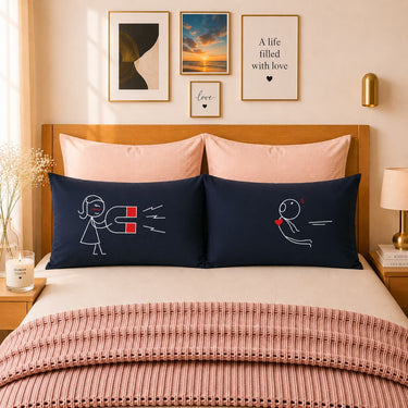 Pair of dark blue couple pillowcases with line art figures and heart accents