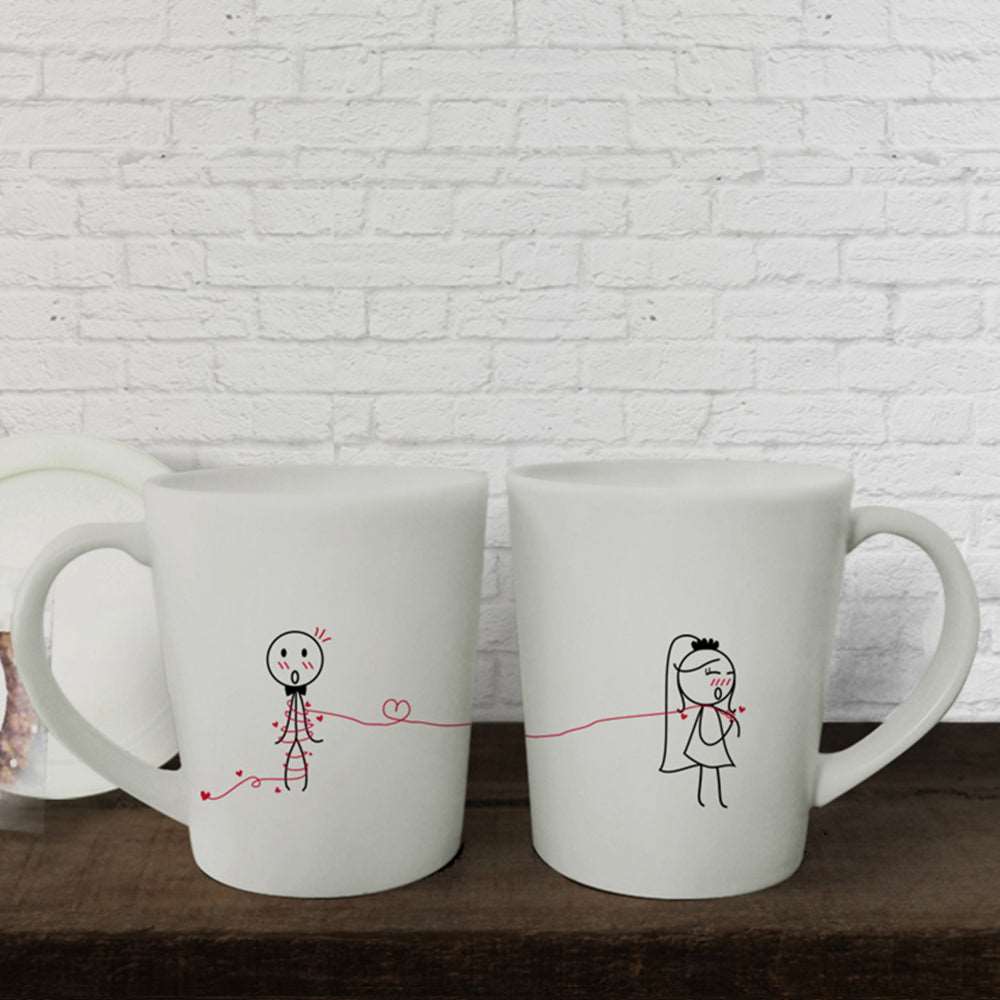 Delightful hand-drawn designs on a pair of pristine white mugs, perfect for couples, anniversaries, or as thoughtful gifts for him and her.