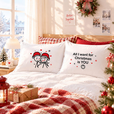 Pair of white Christmas pillowcases with matching couple artwork and “All I want for Christmas is YOU” text