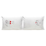 White couple pillowcases with cartoon woman holding red block and cartoon man with heart