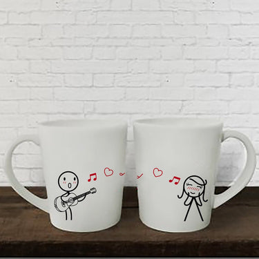 a coffee mug sitting next to a coffee cup 