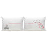 Pair of white pillowcases with red heart-line; bike on left, heart-cloud with hearts