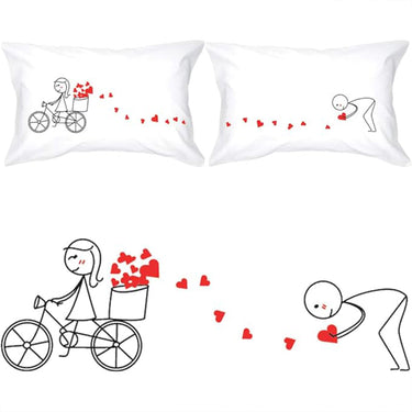 Couple pillowcases, white with line-art couple on tricycle, red heart confetti
