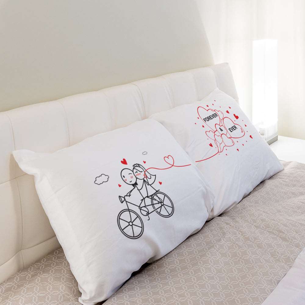Capture their love with a charming couple on a bicycle, surrounded by hearts on a cuddly pillow - an enchanting gift for any occasion!