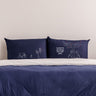 Dark blue couple pillowcases with love quote and stick-figure couple and tree designs